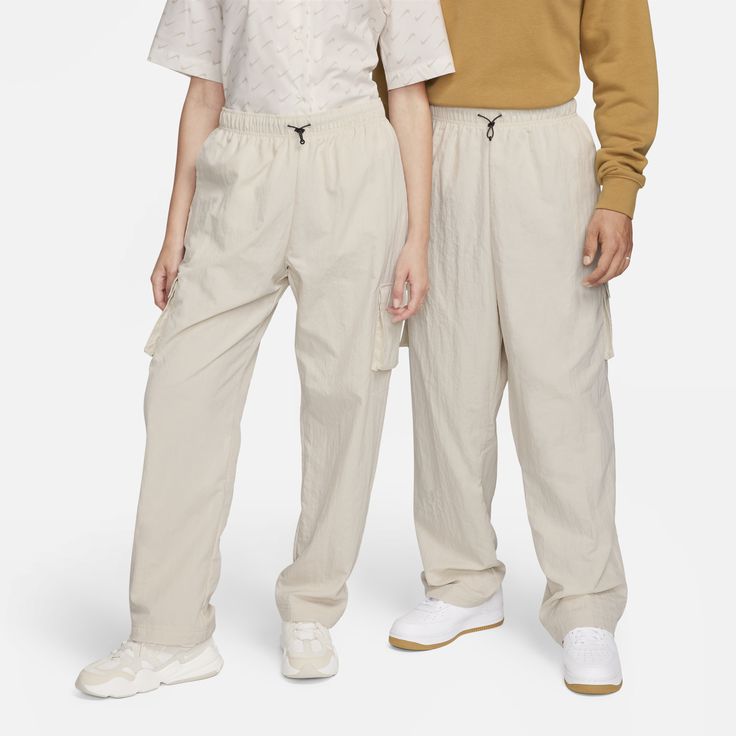 These pants are relaxed through the leg for a carefree, comfortable feel. Unlined woven fabric feels soft and smooth against your skin while still looking crisp. Patch cargo pockets offer a utility look and quick storage. Casual Relaxed Fit Cargo Pants With Hip Pockets, Casual Relaxed Fit Bottoms With Cargo Pockets, Nike Sweatpants With Elastic Waistband For Spring, Relaxed Fit Full Length Cargo Pants For Loungewear, Sporty Leisure Bottoms With Cargo Pockets, Casual Nike Cargo Pants With Side Pockets, Nike Streetwear Bottoms With Side Pockets, Nike Sporty Bottoms With Cargo Pockets, Casual Cargo Pants With Elastic Waistband And Loose Fit