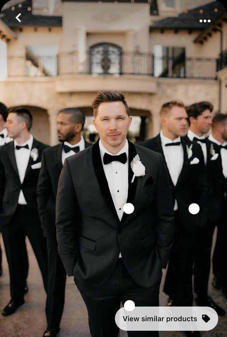 a group of men in tuxedos standing next to each other