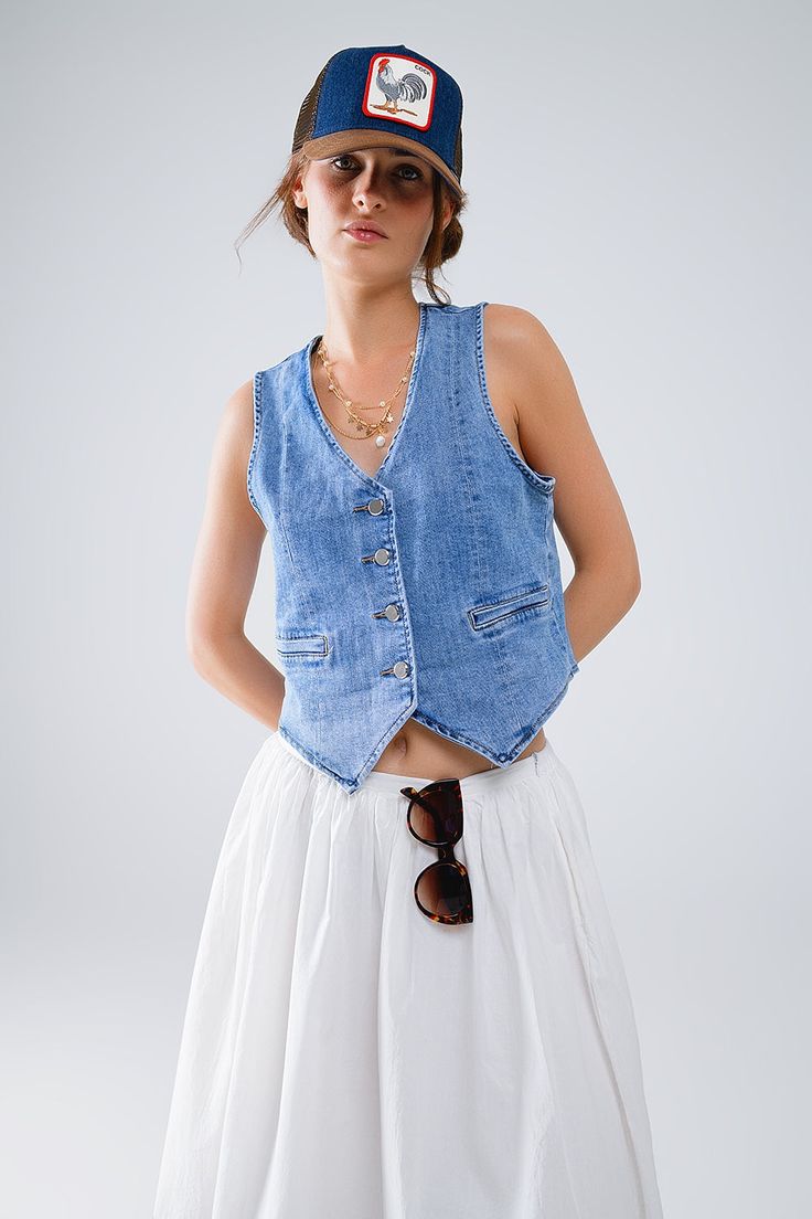 The Fitted Denim Vest is a staple piece for any wardrobe, providing versatility and style. Made from high-quality denim, it offers durability and comfort. With its timeless design, it can be dressed up or down for any occasion. Add it to your collection today. 4 button front closure Decorative pockets V-neck Faux welt pockets Material Cotton elastane blend Machine washable Spring Denim Top With Buttoned Pockets In Medium Wash, Trendy Cotton Denim Vest With Snap Buttons, Spring Medium Wash Denim Top With Buttoned Pockets, Spring Washed Denim Vest For Workwear, Casual Cotton Denim Vest With Buttons, Spring Washed Denim Vest For Work, Button-up Cotton Jeans For Everyday, Medium Wash Button-up Outerwear For Summer, Cotton Button-up Jeans For Everyday