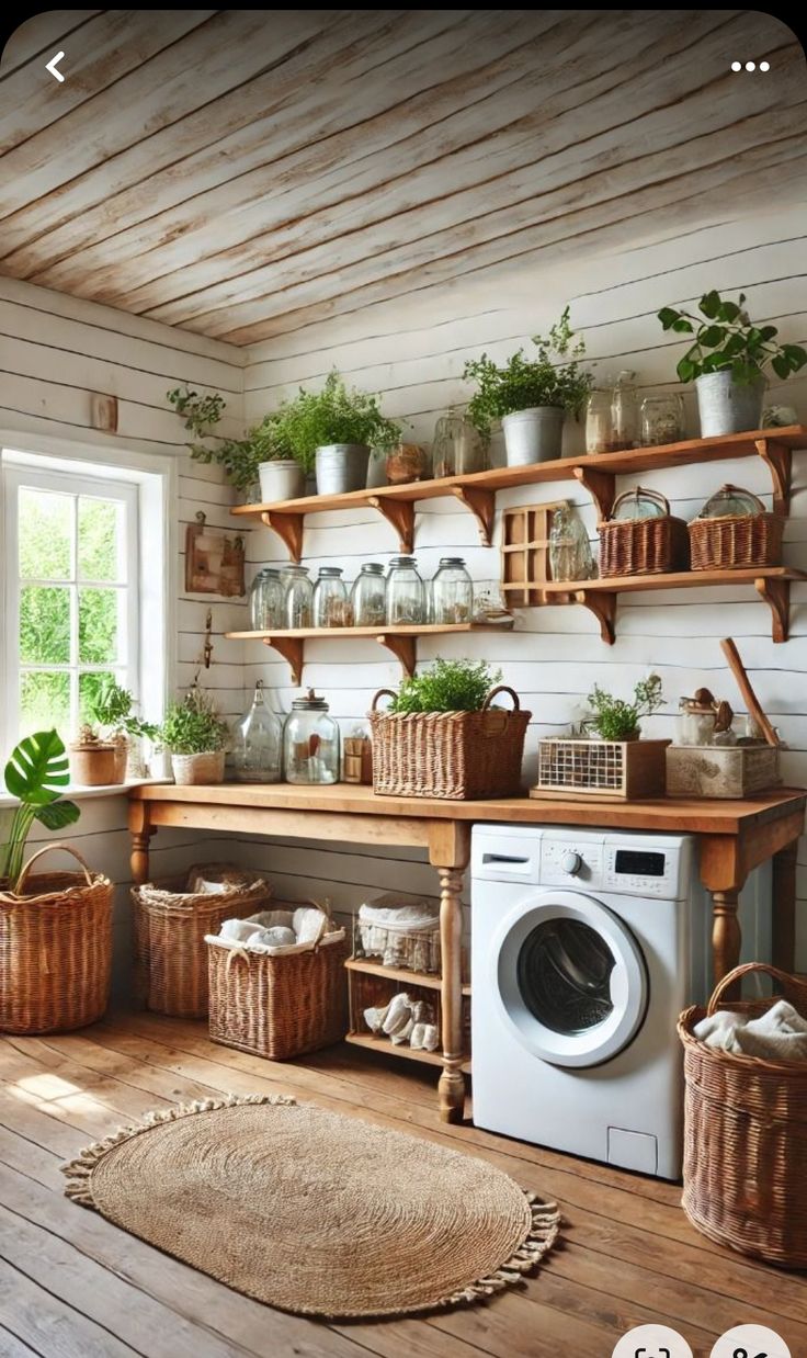 a washer and dryer in a room with wooden shelves on the wall next to a window