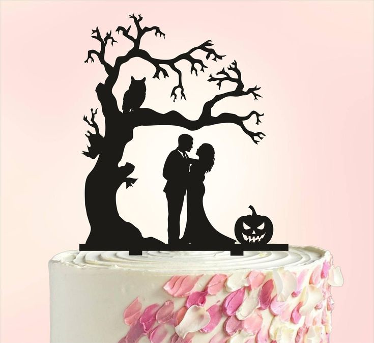 a cake topper that has a couple in front of a tree and pumpkins on it