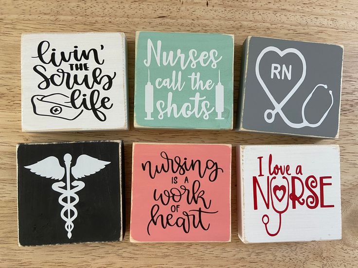 four square magnets with nurse quotes on them sitting on top of a wooden table