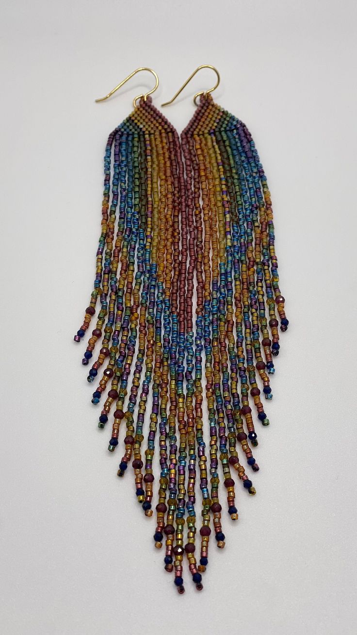 multicolored seed beaded necklace with gold earwires and dangling earrings on white background