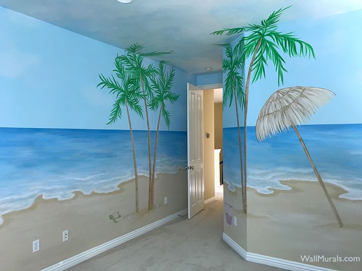 a palm tree painted on the side of a wall in a room with blue walls