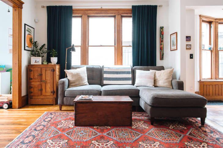 a living room filled with furniture and windows