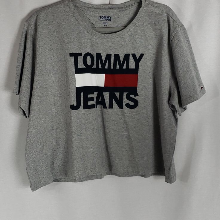 Grey Tommy Jeans Crop Tee Sz Lg. 100% Cotton For Easy Care And Comfort Nwt Never Worn. Iconic Graphic Logo. Spring Cotton Tops With Logo, Spring Cotton Top With Logo, Trendy Tommy Hilfiger Cotton T-shirt, Tommy Hilfiger Graphic Tee With Graphic Print, Tommy Hilfiger Graphic Print Tee, Trendy Gray Tops With Logo Print, Trendy Logo Tops For Spring, Trendy Tops With Logo For Spring, Trendy Summer Tops With Logo