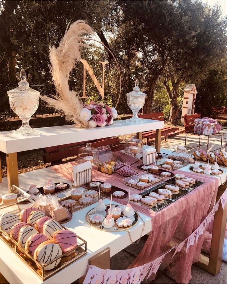 a table topped with lots of desserts and pastries