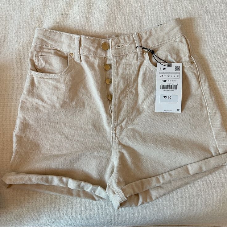 Zara High Rise Mom Shorts Brand New With Tags Size 2 (Us) Color: Beige Inseam: 4” Unrolled And 2” Rolled Rise: 15” Unrolled And 13” Rolled 22” Leg Opening Material: Cotton (Jean) ** I Have 9 Of These In Different Colors But Same Size! Check Out My Page To Add To Bundle And Save! Fast Same- Day Shipping Comes From Brand New Home~Free Of Moldtoxinssmokepet Allergens All Items In My Closet Were Originally Purchased New From Retailers- Never Secondhand Shops Tags: Altar’d State, Abercrombie & Fitch, Zara Cotton Bottoms With Built-in Shorts, Summer Short Pants With Button Closure, Trendy High-waisted Beige Shorts, Summer Bottoms With Button Closure And Short Length, Trendy Cream Bottoms For Summer, Trendy Cream Summer Bottoms, High Rise Cream Bottoms For Summer, Zara Cotton Bottoms Short Length, High-rise Cream Bottoms For Summer