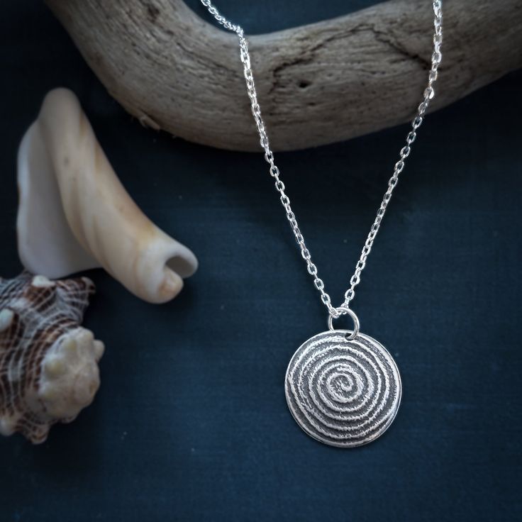 This silver domed spiral necklace remind us of the importance of turning in and listening to the wisdom that is inside of us. Necklace is sterling silver and measures approximately .75" in diameter. It hangs on an 18 inch sterling silver rolo chain. If you would like a longer or shorter chain, or a snake chain, please let me know in the comments section while checking out. The raised areas are polished silver while the recessed areas have a dark patina that accentuates the texture and makes them Sterling Silver Swirl Jewelry In Silver, Sterling Silver Swirl Jewelry, Spiral Shaped Sterling Silver Jewelry, Spiral-shaped Engraved Sterling Silver Jewelry, Nickel-free Sterling Silver Swirl Necklace, Engraved Sterling Silver Spiral Jewelry, Sterling Silver Swirl Necklaces, Spiral Sterling Silver Necklace In Silver, Minimalist Silver Spiral Necklace