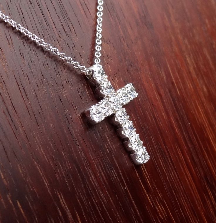 "This 18k white gold pendant is a high quality cross. This cross pendant is 23mm height by 15mm width made in 18k white gold approximately 5.5 grams total weight. It has 11 quality diamonds VS2 - SI1 clarity and G-H color range 1.10 cts total weight. The Italian 18k white gold chain can be 16,17 or 18 inch long . We love these pendant because it represents the way jewelry should be made with craftsmanship and quality. This pendent is anything but ordinary. Our pieces are designed and made with c Aaa Quality Diamond White Jewelry Gift, White Gold Jewelry As Gift, Aaa Quality White Gold Jewelry As Gift, White Gold Hallmarked Cross Pendant Jewelry, Platinum Diamond Necklace With Polished Finish As Gift, Formal Diamond Cut Cross Necklace, Fine Jewelry Cross Pendant For Anniversary, Sterling Silver Cross Jewelry With Brilliant Cut, Anniversary Fine Jewelry Cross Pendant