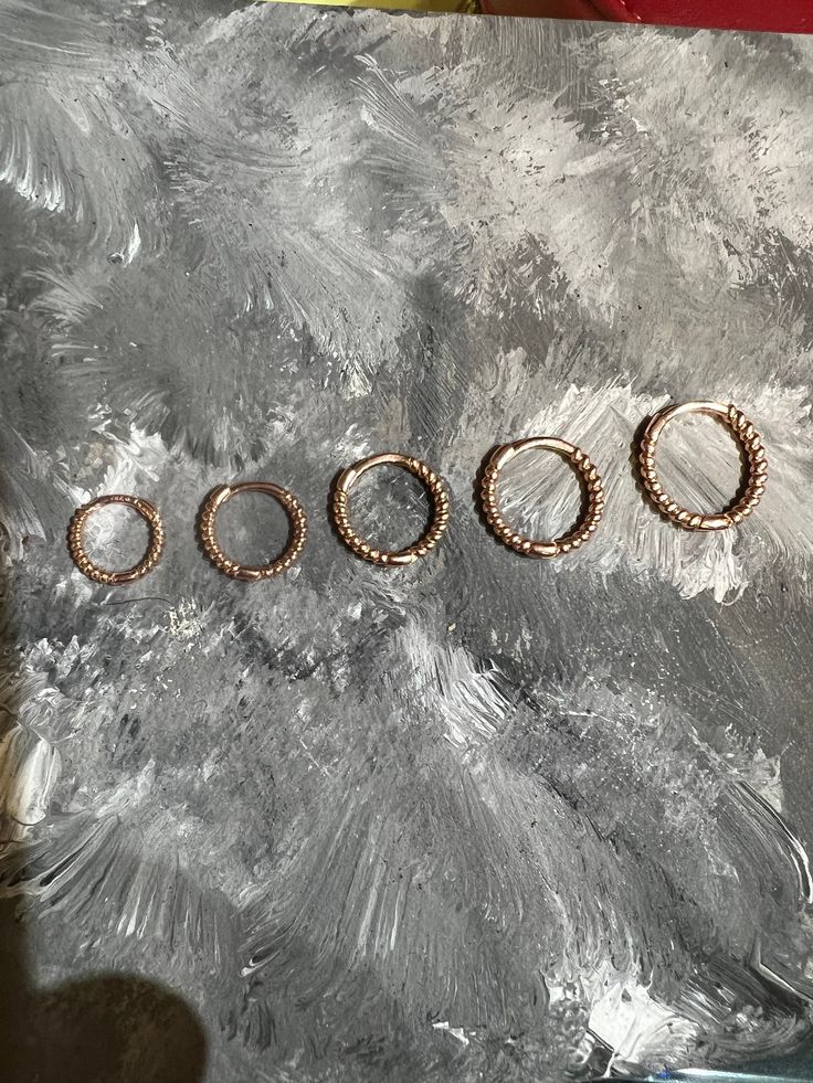 Our 14K Solid Gold Huggie Earrings are an Etsy Bestseller. We found that there were no solid gold seamless cartilage hoops on the market so we made them for you!! All of our jewelry is made from solid 14k rose gold, free of nickel and it hypoallergenic. You can sleep, shower, swim, and live in our jewelry without any irritation!!  Since everyone's ears are different, we work with customers everyday to find the best size for the piercings they are looking to use these hoops for. Please see our si Stackable Rose Gold Hoop Jewelry, Rose Gold Stackable Hoop Jewelry, Nickel Free Rose Gold Cartilage Earrings, Nickel-free Rose Gold Cartilage Earrings, Adjustable Hypoallergenic Rose Gold Huggie Earrings, Rose Gold Small Hoop Piercing For Gift, Rose Gold Small Hoop Piercing As Gift, Rose Gold Round Huggie Earrings, Rose Gold Small Hoop Piercings For Gift