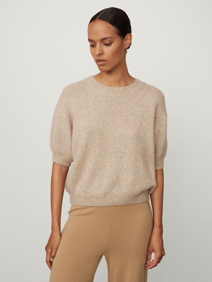 Find Lisa Yang Store The Junie Sweater on Editorialist. The Junie top is knitted in textured cashmere silk (77% cashmere, 23% silk), that offers a light and lofty hand-feel that's created as a go-to for the Spring Summer months. The slightly cropped silhouette features a regular fit with voluminous short sleeves and a neat crew neck. Paired here with the Sofi trousers. Cashmere Crew Neck Knit Top For Layering, Elegant Knit Sweater With Soft Texture, Elegant Fine Knit Cashmere Top, Classic Fine Knit Cashmere Top, Classic Cashmere Fine Knit Top, Elegant Cashmere Crew Neck Top, Elegant Cashmere Knit Top For Layering, Elegant Knit Sweater For Work, Beige Cashmere Tops For Fall