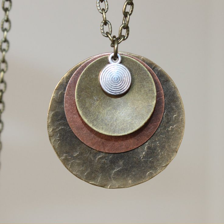 "Boho Necklace Pendant Bohemian Necklace pendant Boho Jewelry Necklace Pendant Mixed Metal Pendant Necklace Brass Necklace Bohemian Jewelry Finish : Antiqued Brass ( 32mm ) Copper Brass disc round Length : 19 inches for the antiqued brass chain and 1\"1/4 for the bigger metal Copper Disc Matching Earrings : https://www.etsy.com/listing/493613967/boho-earrings-copper-earrings-dangle?ref=shop_home_active_9 Necklace section : https://www.etsy.com/shop/NtikArtJewelry?section_id=16089749 To return to Adjustable Pendant Layered Necklace, Bohemian Brass Charm Necklace With Round Pendant, Hippie Metal Necklace For Gifts, Hippie Metal Necklace For Gift, Bohemian Oxidized Copper Jewelry, Hippie Style Metal Jewelry Gift, Nickel-free Brass Necklace In Brown, Bohemian Jewelry With Adjustable Chain And Medallion, Bohemian Jewelry With Medallion And Adjustable Chain