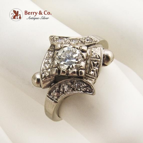 Art Deco 14 K (.585) white gold ring with a round cut Diamond centerpiece - 0.5 carat, SI-2 clarity, G color. The bezel is accented with 6 single cut Diamonds, 1.5 mm in diameter each. c. 1920. This magnificent ring is a size 6 3/4 and weighs 4.1 grams. Eb8282 Art Deco Diamond White Ring With Bezel Setting, Art Deco White Gold Diamond Ring With Bezel Setting, Art Deco White Diamond Ring With Bezel Setting, Art Deco Diamond Ring With Bezel Setting, Art Deco Silver Diamond Ring With Bezel Setting, Silver Art Deco Diamond Ring With Bezel Setting, Art Deco Diamond Ring With Diamond Accents, 14k White Gold Diamond Ring With Round Stone, Art Deco Diamond Ring With Accents