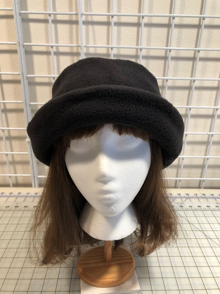 I made this beautiful fleece hat out of a rich black anti-pill fleece and lined it with a matching color fleece for warmth and body. It's sized to fit most adults 22-23 inches around head. The brim can be worn up or down. It's a very comfortable fit on my 22 1/2 inch head. Machine wash and dry, gentle cycle. A great travel hat for any season. If you would like a different color, contact me and I'll let you know if I can make it. Handmade in Oregon. Black Windproof Hat With Short Brim, Black Windproof Brimmed Hats, Black Windproof Short Brim Hat, Black Felt Cap For Winter, Black Windproof Hat With Curved Brim, Black Felt Cap For Outdoor, Black Winter Felt Hat, Black Winter Cloche Hat, One Size Fits Most, Black Wool Cap For Winter