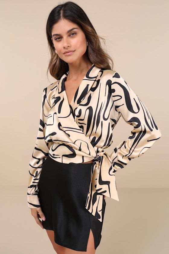 Let the Lulus Artistic Inspiration Beige Abstract Print Satin Wrap Top be your base for a perfect weekday look! Sleek woven satin shapes this stylish top that has a bold, abstract print throughout. Long sleeves (with button cuffs) frame a wrap bodice with a collared neckline and shawl-style lapels. Banded waist secures with a slender internal tie and a chic sash at the side. Lightly cropped hem. Fit: This garment fits true to size. Length: Size medium measures 18.5" from shoulder to hem. Bust: G Chic V-neck Blouse With Graphic Print, Chic V-neck Top With Bold Print, Chic Long Sleeve Blouse With Abstract Print, Chic Patterned Tops With Abstract Print, Chic Silk Top With Abstract Print, Trendy Abstract Print Tops For Party, Trendy Abstract Print Party Tops, Spring Party Tops With Abstract Print, Abstract Print Patterned Tops For Workwear