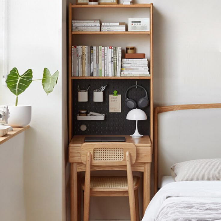 a bedroom with a desk and bookshelf next to a bed in front of a window