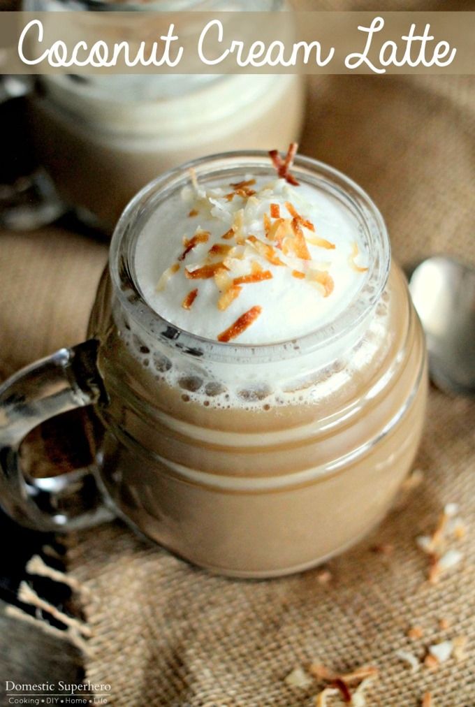 two cups filled with whipped cream on top of a table