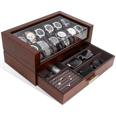 an open wooden watch box with many watches in it on a white background, there is also a pair of sunglasses