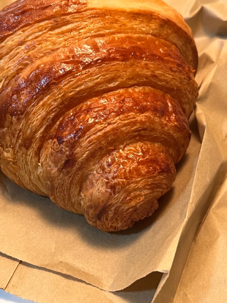 two croissants sitting on top of white paper