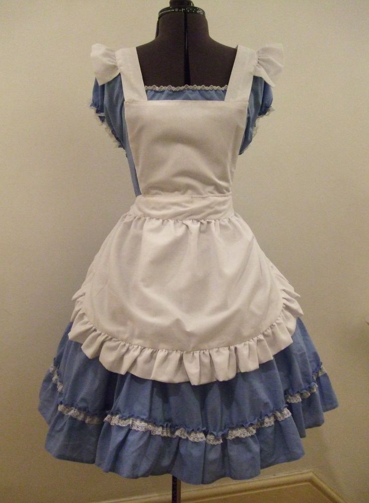 a white and blue dress on a mannequin with ruffles around it