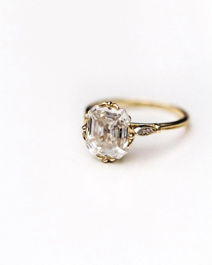 an engagement ring with a large diamond in the center and two small diamonds on each side