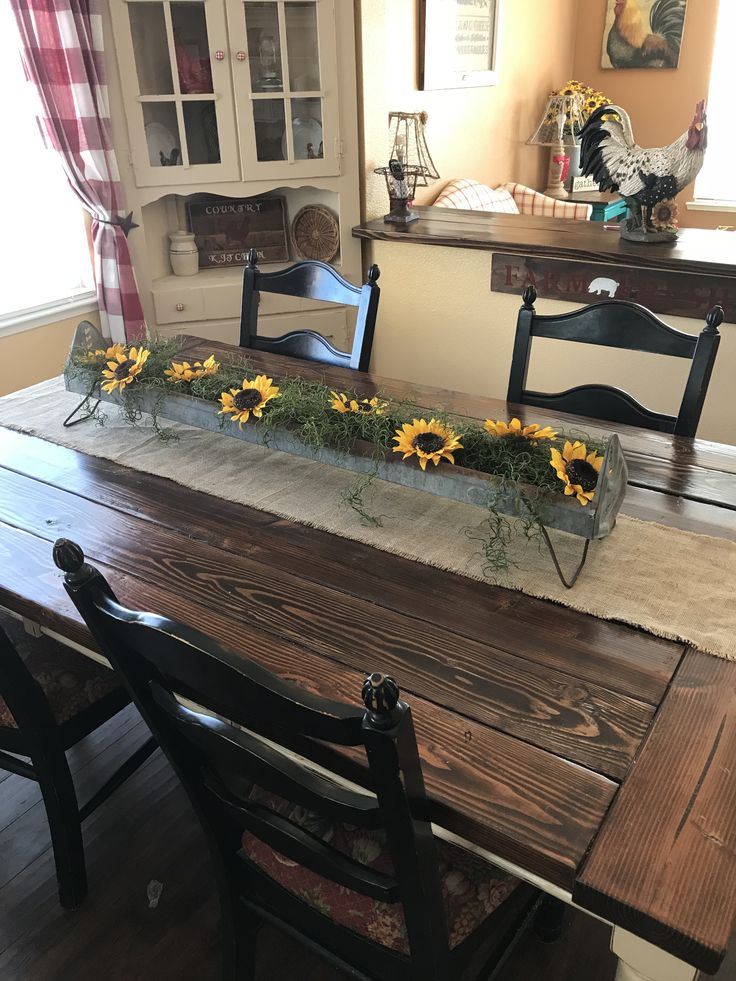 a wooden table with sunflowers on it