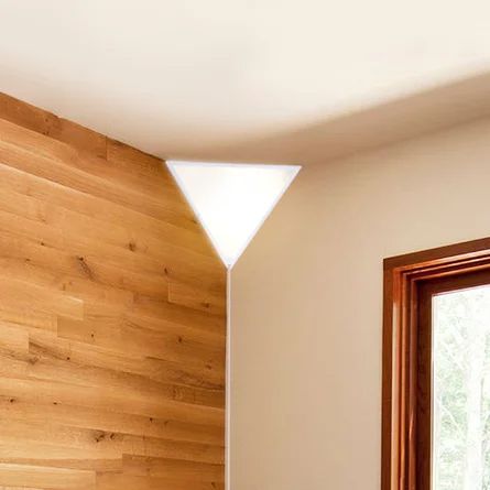 a bedroom with wood paneling and white walls