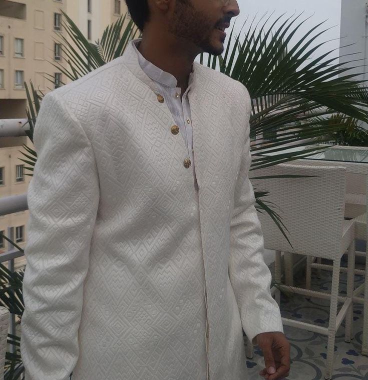 White  Indo Westerni With all Over Embroidery Comes With A Black Trouser In Cotton * Fabric Is Self Weaved Silk  * Colour Is White  With All Over Embroidery Work * Paired with a Perfectly Matching White TrouserChudidar We Will Do Custom Stitching as per our body measurements Just Like You visit a tailor for stitching  We Will Take Your Body Measurements In whtsapp/Telegram/FB/Zoom Video call Thank You for Visiti Traditional Bollywood Wedding Suits With Drape, Bollywood Style Suits With Traditional Drape For Weddings, Bollywood Style Wedding Suit With Traditional Drape, Bollywood Wedding Suits With Zari Work, Formal White Lehenga With Dabka Work, White Naqshi Lehenga For Wedding, Fitted Sherwani With Dabka For Wedding, Traditional Suits For Wedding And Eid, Formal Naqshi Lehenga With Traditional Drape