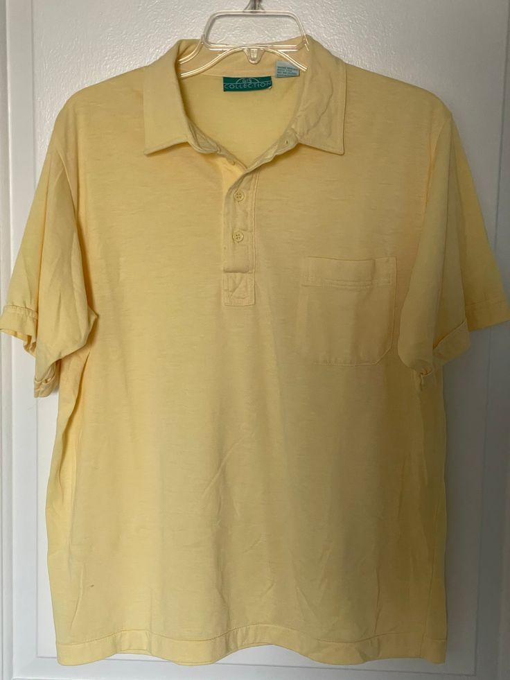 Very nice condition shirt from the 1980s by 615 Collection.  Very light yellow, almost sheer shirt in a very lightweight cotton/polyester blend great for the warmer weather.  The shirt has a pointed collar, four button placard and a left breast pocket.  Marked as a L Chest measures 21" (42 chest) Yellow Polo Collar Shirt For Summer, Casual Yellow Tops With Pockets, Casual Yellow Top With Pockets, Spring Solid Polo Shirt With Collared Neckline, Yellow Collared Polo Shirt For Summer, Yellow Polo Collar T-shirt For Summer, Yellow Polo Shirt With Collar For Summer, Summer Yellow Polo Shirt With Polo Collar, Yellow Short Sleeve Polo Shirt For Spring