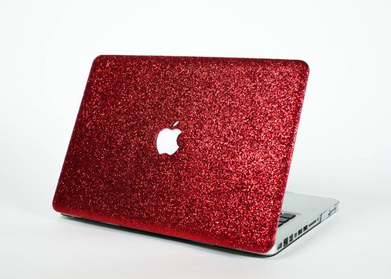 an apple laptop computer covered in red glitter