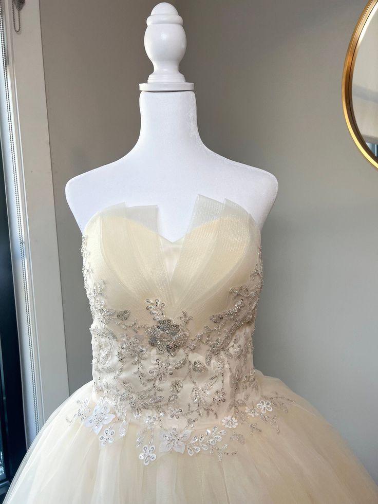 This gown is finished with shimmering tulle, beaded sequins and a corset top for a snug, perfected fit. It can be worn with or without a petti coat (which is not included). Item will arrive folded in a dress bag. If you decide this is the dress for your big day: We advise steaming the dress to get any creases out due to being folded for shipping. Feel free to contact us with any questions. Ball Gown With Sheer Fitted Bodice For Quinceanera, Quinceanera Ball Gown With Sheer Fitted Bodice, Fitted Organza Ball Gown With Corset Back, Glamorous Corset Dress For Debutante Ball, Fitted Organza Corset Ball Gown Dress, Glamorous Boned Bodice Corset Dress For Debutante Ball, Fitted Bodice Organza Corset Ball Gown, Organza Corset Ball Gown With Fitted Bodice, Glamorous Corset Dress With Fitted Bodice