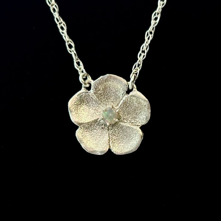 Inspired by a rare Victorian genre of jewelry , our new Forget-Me-Not Necklace is handmade in textured sterling silver with a semi-precious stone in the center. The name Forget-Me-Not comes from a German legend about a knight who died trying to obtain these flowers for his lover, calling out with his last breath, "forget me not!" They are therefore known to symbolize true love. Handcrafted in Sterling silver or 14k gold Set with one approx. 2mm stone (opal or diamond) Set on a 16" chain, fastene Hand Forged Flower Pendant Necklace As Gift, Nature-inspired Flower Gemstone Jewelry, Sterling Silver Flower Pendant Necklace For Memorial, Elegant Memorial Jewelry With Flower Charm, Nature-inspired Flower Pendant Jewelry For Anniversary, Silver Flower Jewelry For Memorial, Flower Shaped Hand Forged Jewelry Gift, Hand Forged Flower Jewelry Gift, Hand Forged Flower Shaped Jewelry Gift