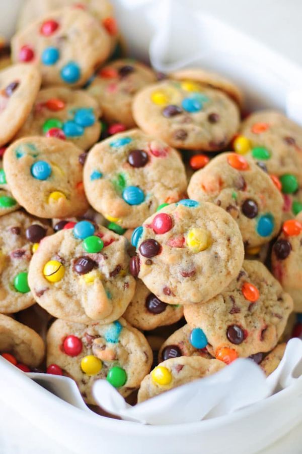 chocolate chip cookies with m & m and sprinkles in a white bowl