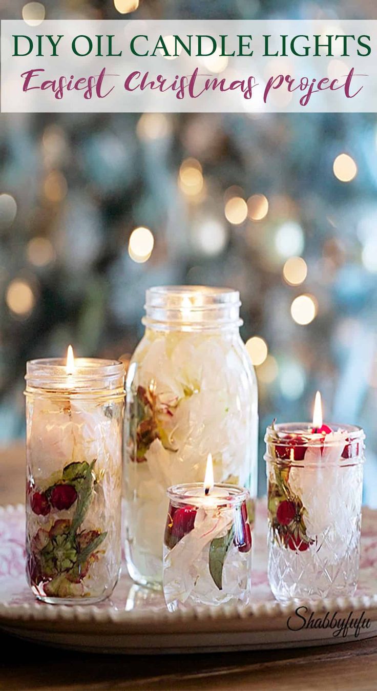 three mason jars filled with flowers sit on a tray next to candles and a christmas tree in the background