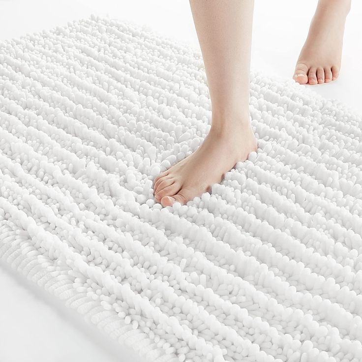 a person standing on top of a white rug