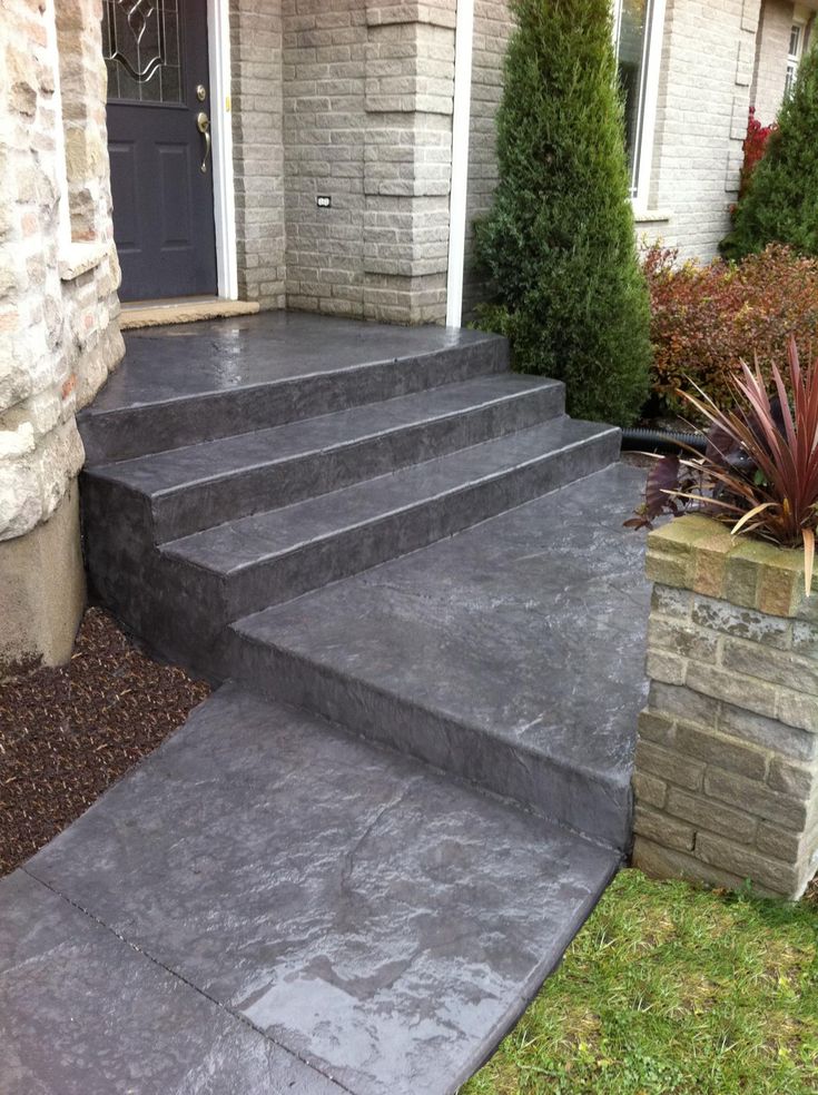 concrete steps leading to the front door of a house