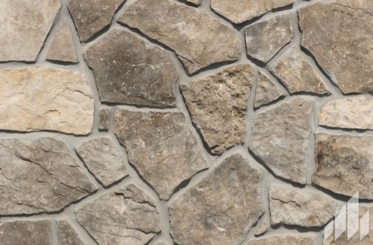 a stone wall that is made out of various types of stones and has been used as a background