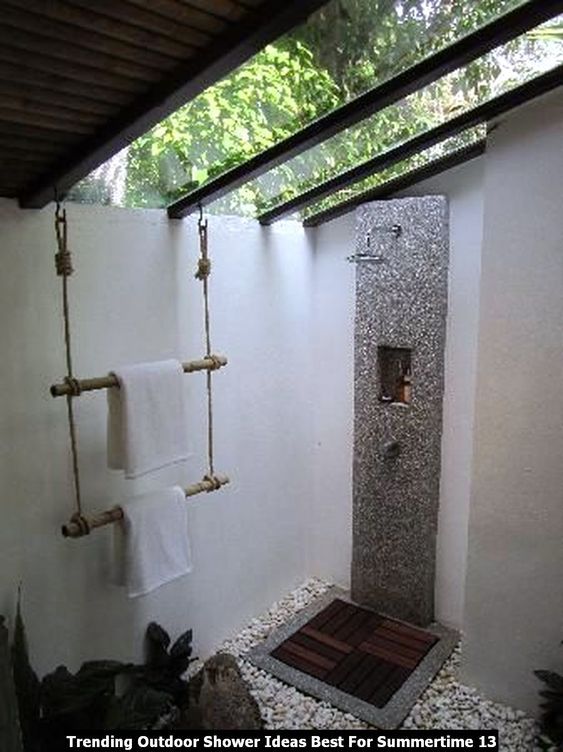 a bathroom with a stone shower and white towels