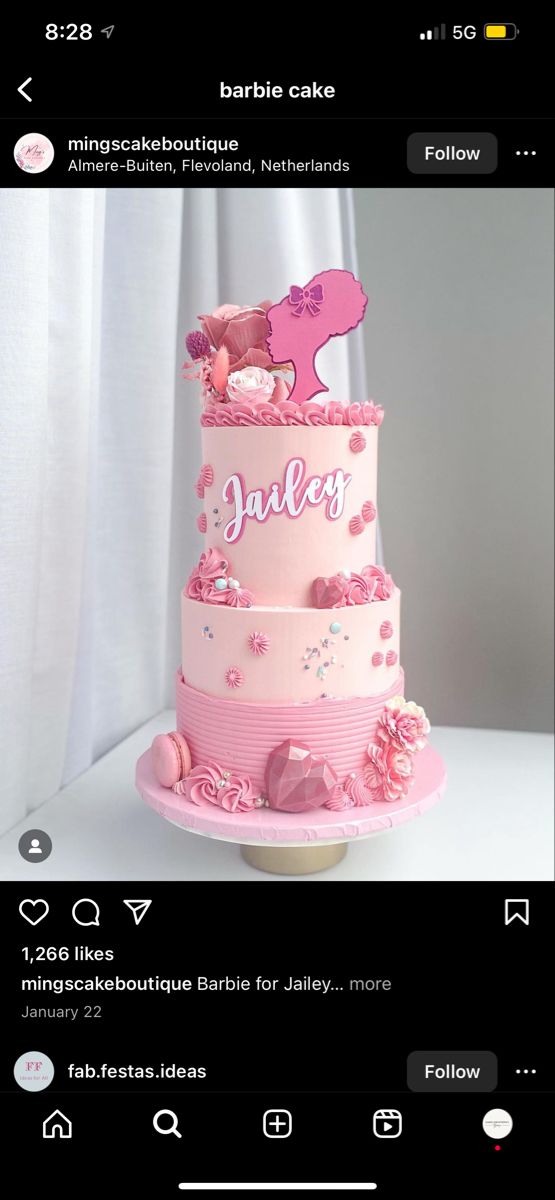 a three tiered cake with pink frosting