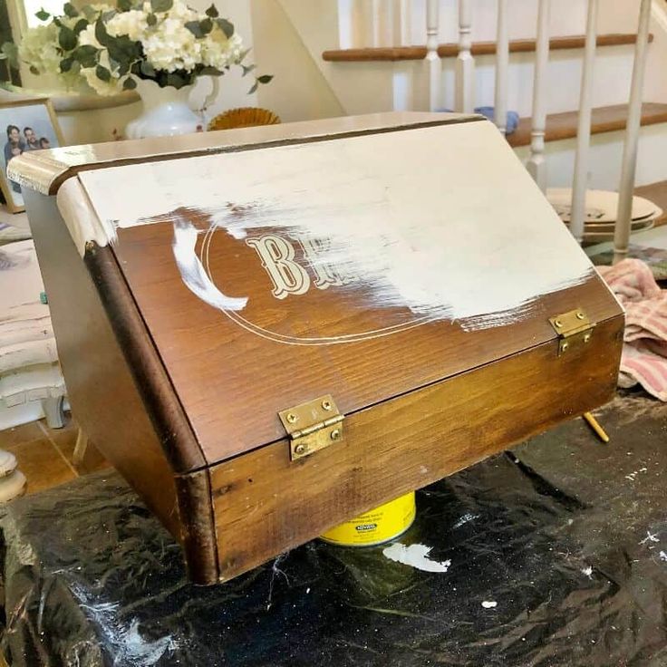 an old wooden box with the letter b painted on it sitting on top of a table