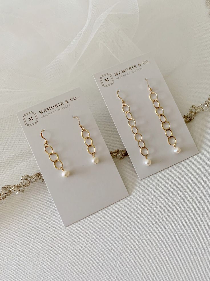 "Our elegant freshwater pearl dangle earrings are perfect for bridesmaids' gifts, bridal jewelry or for any occasion to dress up. Pearls measure approximately 4.5mm and fall from 14k gold filled links. The earrings are available in two lengths - 1 1/2\" or 2\". If you are ordering several pair and would like these individually boxed, please make a note in the comment section at checkout. Otherwise, they will be packaged in as few boxes as possible to avoid waste. About gold filled jewelry: Gold Pearl Chandelier Earrings With Pearl Chain As Gift, Elegant Gold Pearl Earrings For Mother's Day, Feminine Gold Pearl Earrings For Wedding, Dainty Ear Wire Bridal Earrings For Anniversary, Dainty Bridal Earrings With Ear Wire For Anniversary, Elegant Hypoallergenic Earrings For Mother's Day, Elegant Pearl White Bridal Accessories As Gift, Pearl Drop Earrings For Anniversary And Mother's Day, Elegant Drop Earrings For Mother's Day