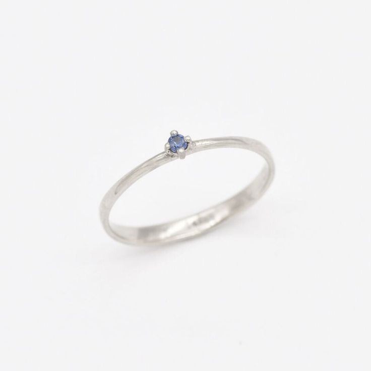 Dainty Sapphire Ring set with Natural Sapphire, size 2 millimetres diameter, 0.03 Carats. Solid 14k White Gold ☞ made to last. Click here for ☞ Solid Gold CollectionSapphire Details:• CERTIFIED Sapphire • Weight: 0.03 Carats• Dimensions: 2 millimeters• Color: Blue• Cut: Round• Origin: BurmaSetting Details:• 1.20 grams of 14k Solid White Gold• Dimensions: Band width ≈ 2.2mm, thickness ≈ 0.7mm• Non-Tarnish - Perfect for Everyday Use - Lasts a Lifetime *Final weight & dimensions depending on the ch Stackable Sapphire Diamond Ring As Gift, Dainty White Gold Birthstone Promise Ring, White Gold Dainty Birthstone Ring With Prong Setting, Sapphire Brilliant Cut Promise Ring, Dainty White Gold Birthstone Ring With Prong Setting, Delicate White Gold Birthstone Ring With Round Cut, Round Cut Silver Birthstone Ring In 14k Gold, Dainty 14k Gold Sapphire Ring With Prong Setting, Dainty 14k White Gold Sapphire Ring