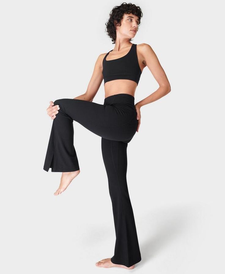 Our statement trousers for yoga flows and more. Exclusive fabric is supportive, breathable, sweat-wicking and 90% squat-proof. Super-high rise waist with a slim, flared fit. Slits at the ankles for an exaggerated silhouette. Features a side pocket and adjustable drawcord at the waist. Inseam length size S: 30" / 74cm. Model wears size S, 32" inseam and is 178cm/5'10"" tall. Style Code: SB8270SColour: Black Yoga Flows, Yoga Trousers, Flare Yoga Pants, Black Yoga, Cropped Tops, Sweaty Betty, Black Legs, Active Wear Tops, Women's Trousers