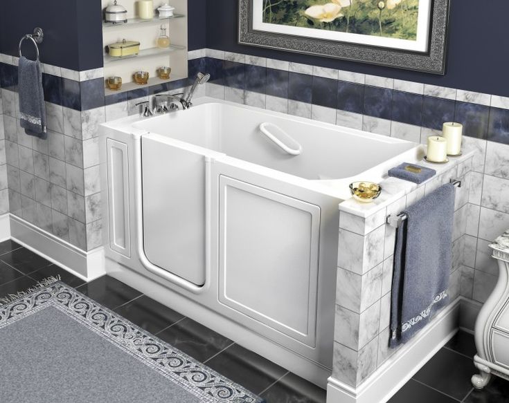 a white bath tub sitting next to a toilet