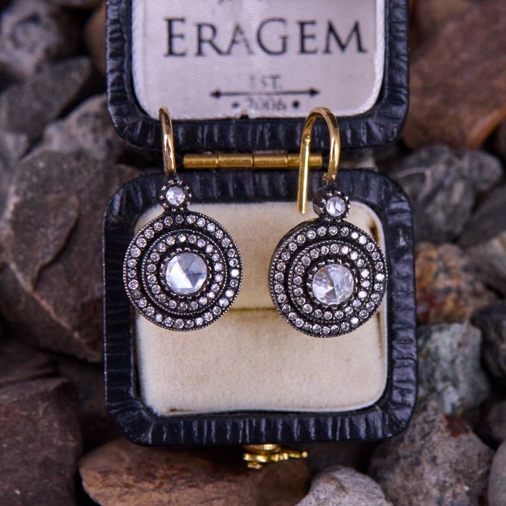 This pretty pair of Victorian style silver topped 18k yellow gold earrings are each accented with two (2) bezel set rose cut diamonds, and fifty (50) bead set round brilliant cut diamonds. The diamonds are bordered with milgrain edging and antiquing. The earrings measure 21.8mm X 11.5mm and are finished with 18K yellow gold lever backs. Fine Jewelry Diamond Earrings With Rose Cut, Fine Jewelry Earrings With Rose Cut Diamonds, Exquisite Drop Diamond Earrings With Single Cut Diamonds, Exquisite Single Cut Diamond Drop Earrings, Fine Jewelry Rose Cut Diamond Earrings, Rose Cut Diamond Earrings Fine Jewelry, Luxury Drop Earrings With Single Cut Diamonds, Luxury Single Cut Diamond Drop Earrings, Anniversary Earrings With Rose Cut Diamonds