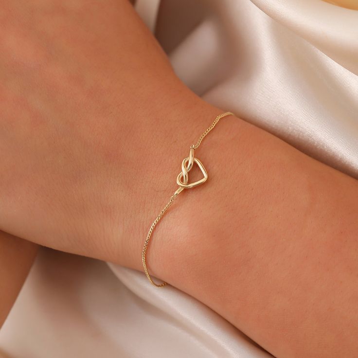 Tiny Knot Bracelet, 14K Solid Gold Heart Knot Bracelet, Dainty initial Unique Love Bracelet, Handmade 14K Gold Knot Bracelet, Great Gift For Her, Summer Jewelry, Anniversary Bracelet, Birthday Gift, Christmas Gift, Solid Gold Bracelet, Minimalist Gold Bracelet, Wedding Bracelet, Valentine's Day Gift "Material: SOLİD GOLD (No Gold Filled Or No Gold Plated)" "KARAT: 14K (585) "Bracelet Length: 11 MM "Bracelet Width: 7,5 MM "Available Gold Color: (Yellow Gold, White Gold, Rose Gold) "The certificat Elegant Adjustable Open Heart Bracelet, Minimalist Yellow Gold Heart Bracelet For Anniversary, Elegant Open Heart Bracelet As Gift, Elegant Open Heart Bracelet For Gift, Elegant Open Heart Bracelets For Mother's Day, Elegant Everyday Charm Bracelet For Valentine's Day, Elegant Open Heart Bracelets, Elegant Open Heart Bracelets As Gift, Dainty Heart-shaped Formal Bracelets