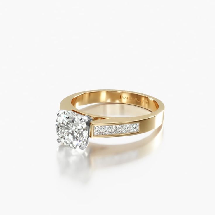 a yellow gold engagement ring with a single diamond in the center and side stones on each band