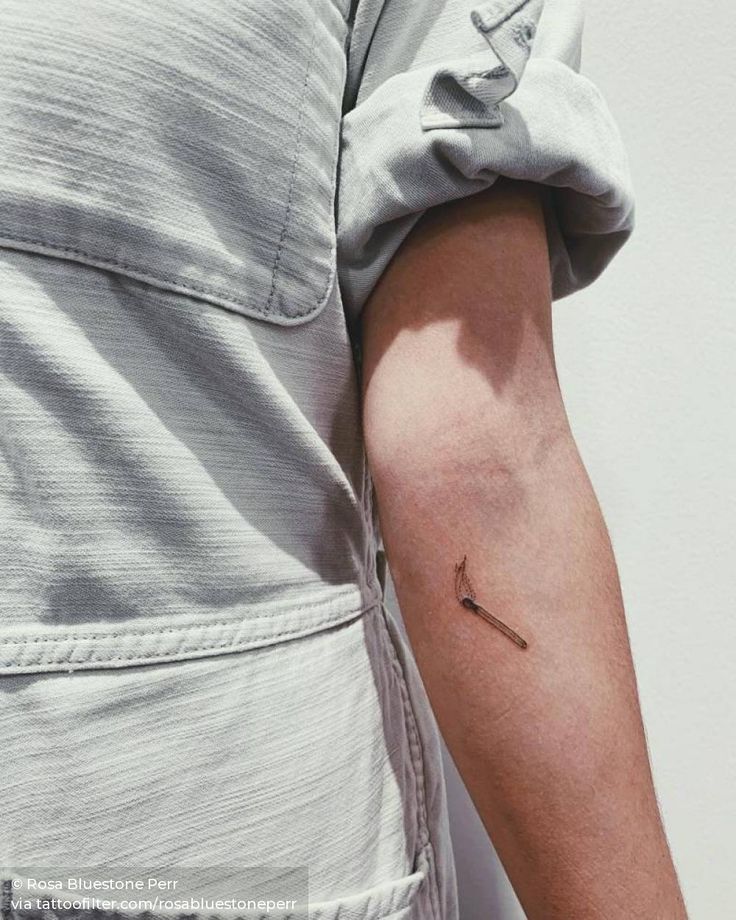 a person's arm with a small tattoo on the left side of their arm