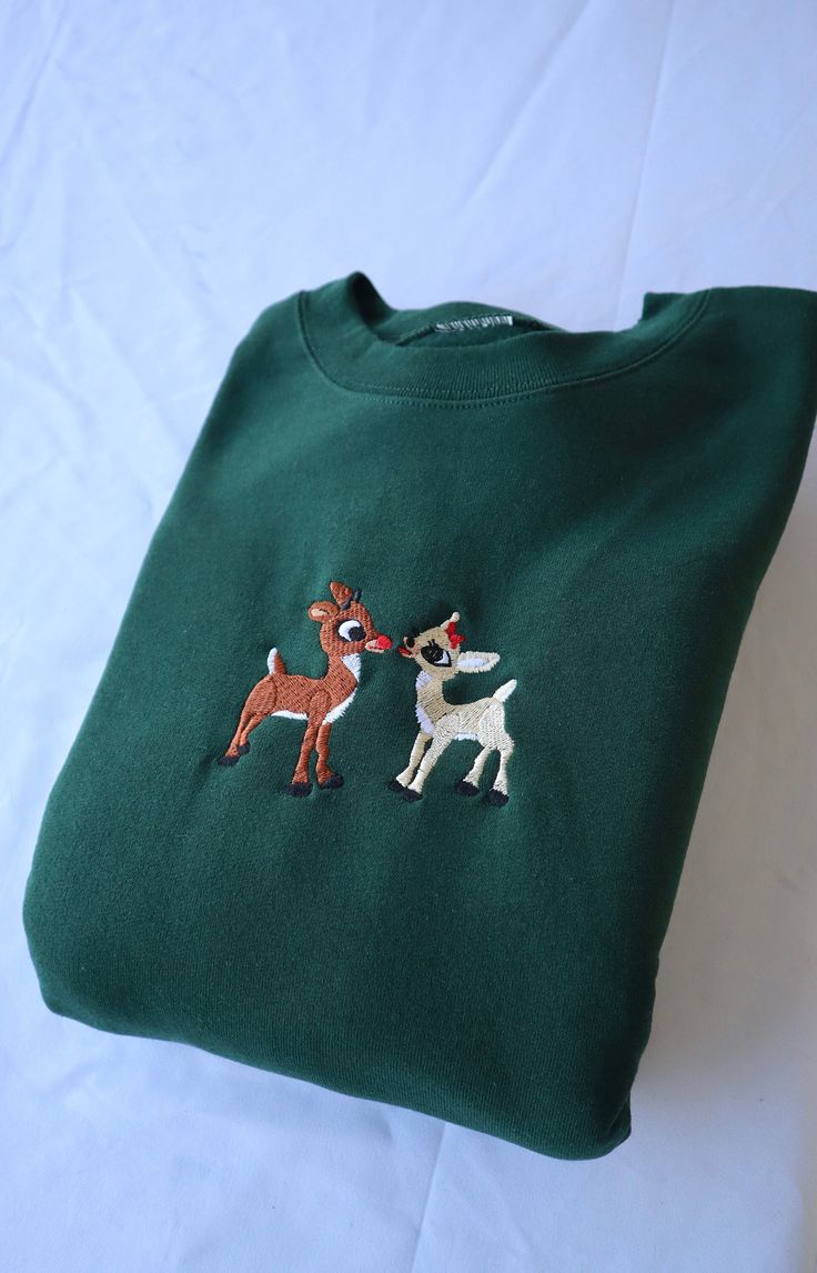 Custom Embroidered Christmas Deer. Step into the spirit of Christmas with style and comfort!  This is a premium quality hooded sweatshirt or crewneck, featuring a beautifully embroidered design. The embroidery is intricately done with high precision, ensuring that the design stands out prominently. The thread used for the embroidery is durable and colorfast, adding a touch of elegance and sophistication to the garment. The sweatshirt itself is made from soft, comfortable fabric perfect for any weather. Its hood or crewneck design adds a casual yet stylish touch. Perfect for those who want to make a subtle yet impactful statement with their wardrobe. Hooded Fall Sweatshirt Gift, Fall Gift Hooded Sweatshirt, Fall Hooded Sweatshirt, Hooded Winter Sweatshirt Gift, Winter Gift Hooded Sweatshirt, Embroidered Long Sleeve Christmas Sweatshirt, Winter Crew Neck Sweatshirt With Custom Embroidery, Fall Season Hoodie Sweatshirt As A Gift, Fall Sweatshirt Hoodie As A Gift